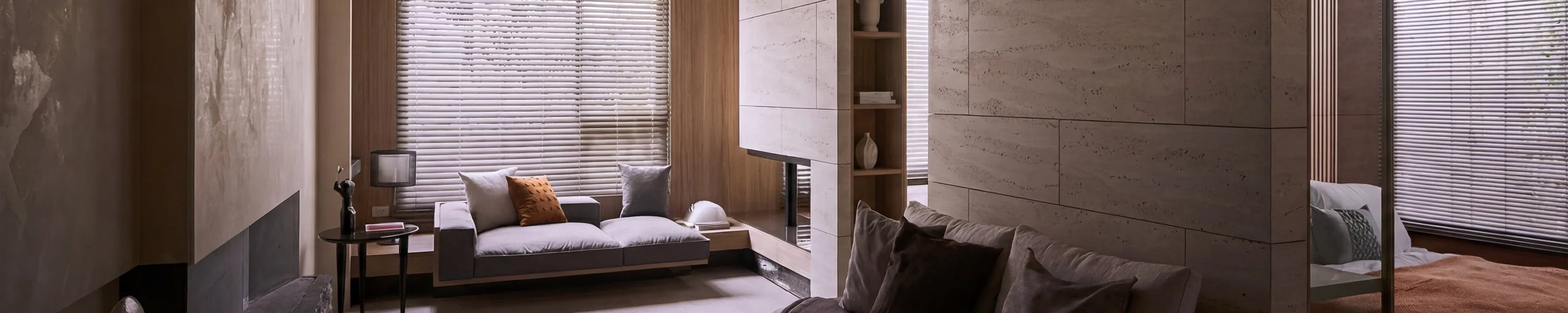 Modern living room with a sofa, coffee table, and smart blinds.