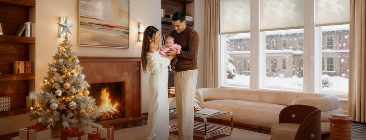 Family in a living room with a Christmas tree, fireplace, and smart blinds.