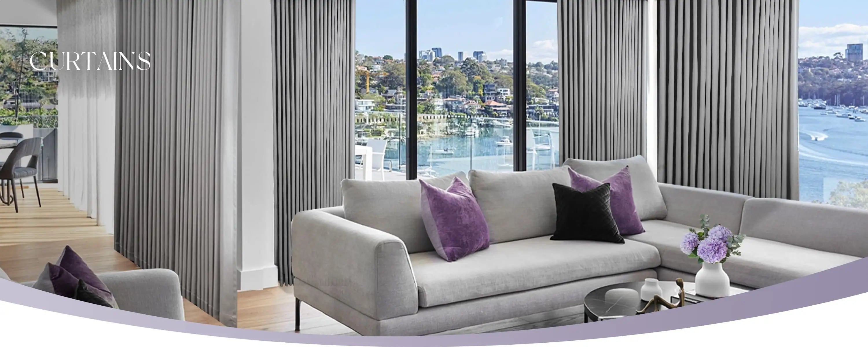 Living room with gray sofa, purple pillows, and striped curtains overlooking a waterfront view.