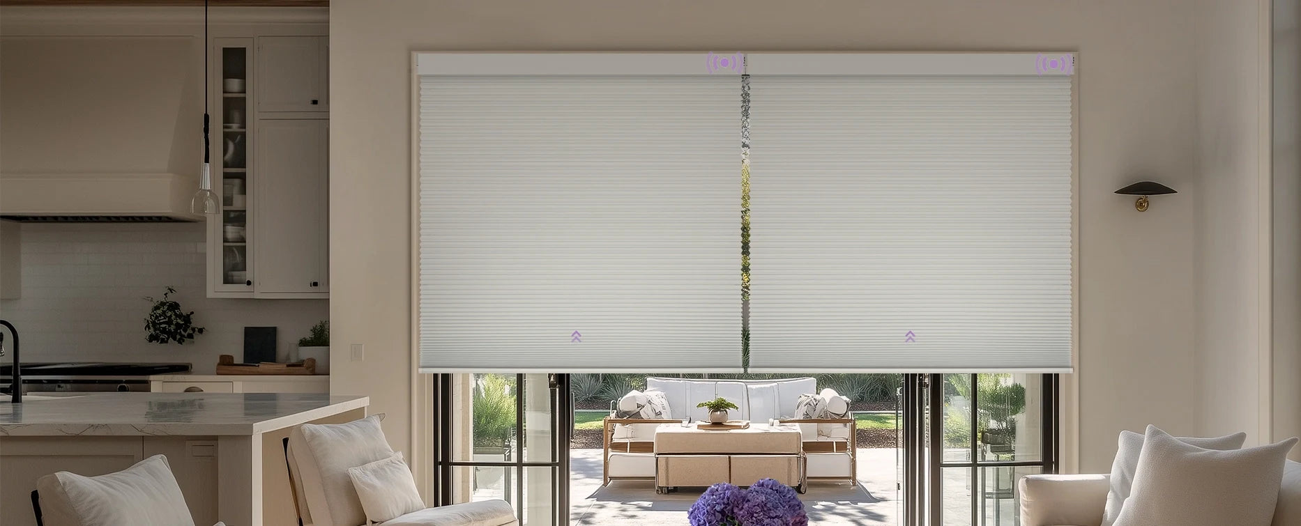 Living room with a large window covered by a roller blind, kitchen in the background