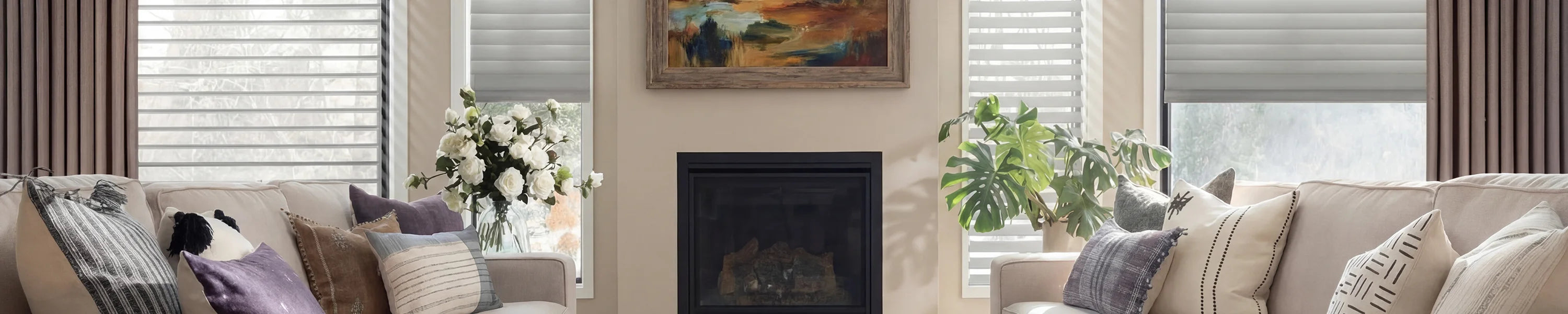 Living room with beige sofa, fireplace, and smart shades.