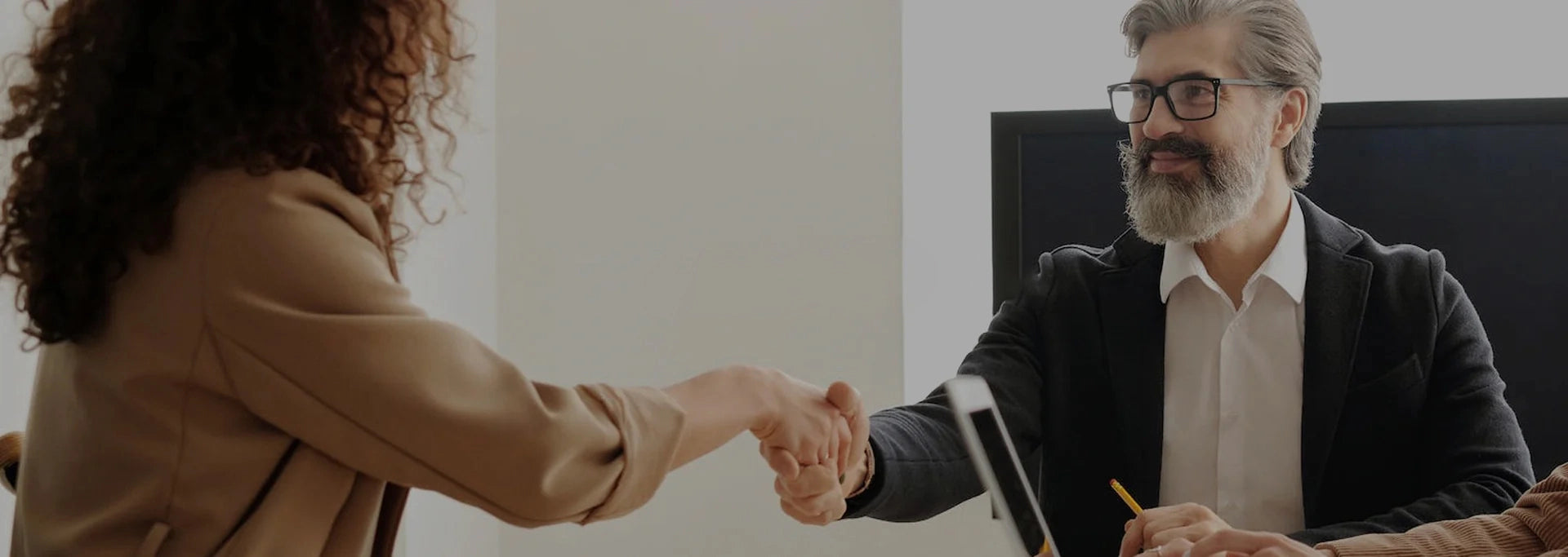 Two people shaking hands in a professional setting