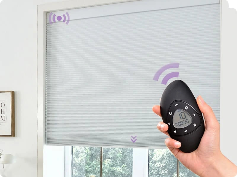 Smart cellular shades with a remote control in front of a window