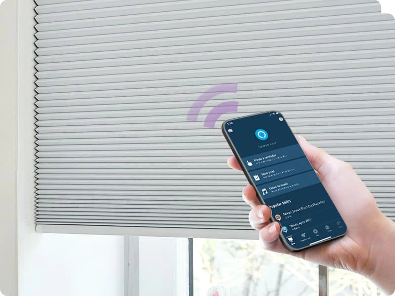 Person using a smartphone app to control smart cellular shades.