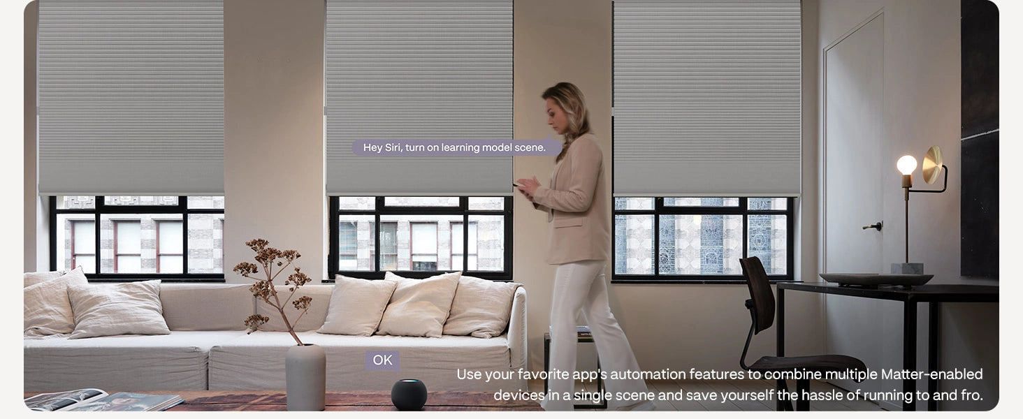 Woman using a smart home device in a modern living room with smart blinds.