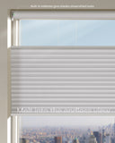Window with light gray blinds and a cityscape view, featuring text about built-in batteries.
