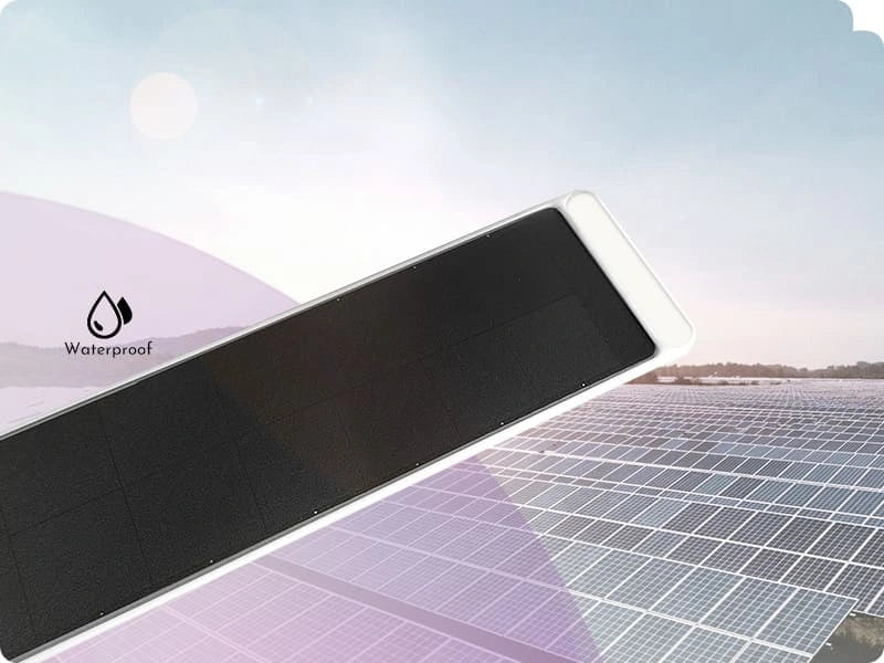 Solar panel with 'Waterproof' label against a clear sky