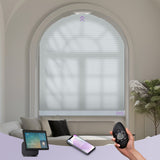 Smart window blinds with control devices on a bed and couch