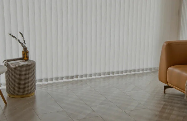 Living room with vertical blinds, brown chair, and small table with a plant.