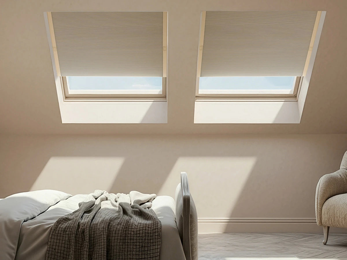 Bedroom with two large skylights and skylight shades allowing natural light to fill the room.