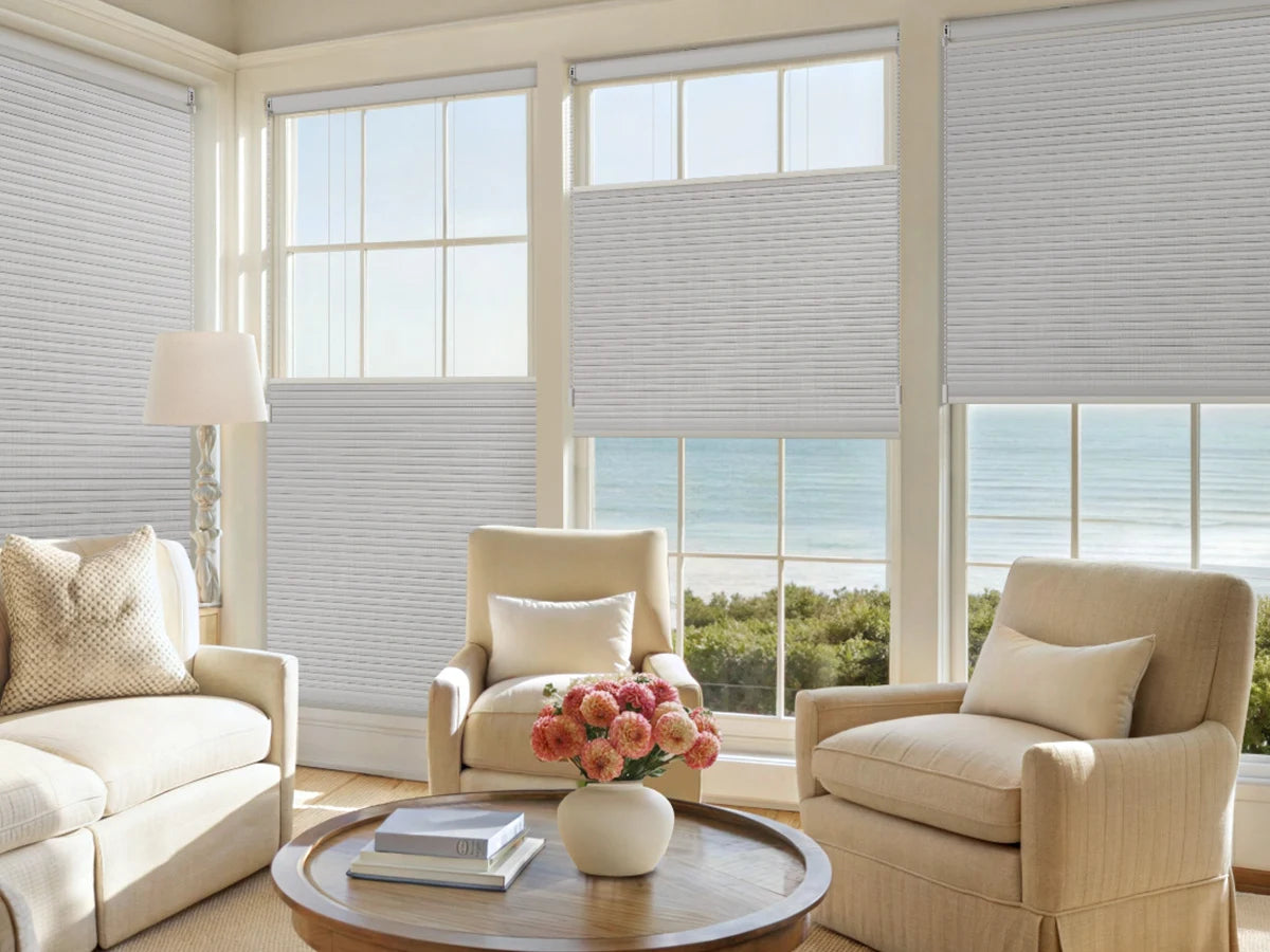 Living room with beige furniture, large windows, and top down bottom up blinds.