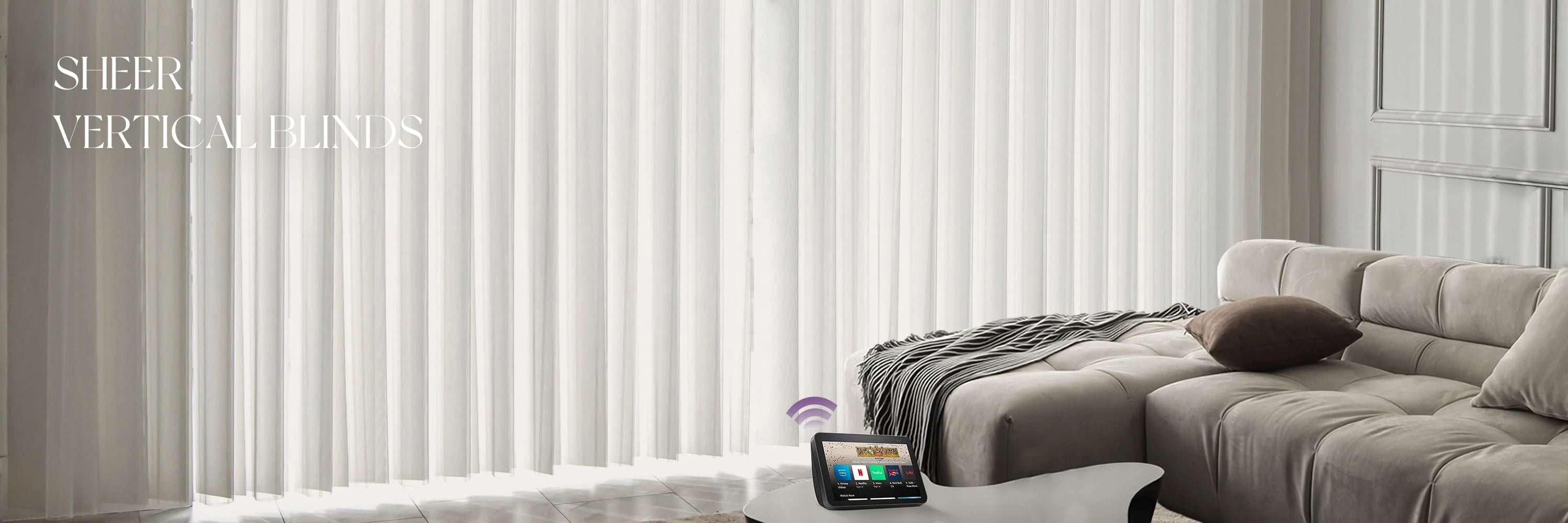 Sheer vertical blinds in a living room setting with a sofa and coffee table.