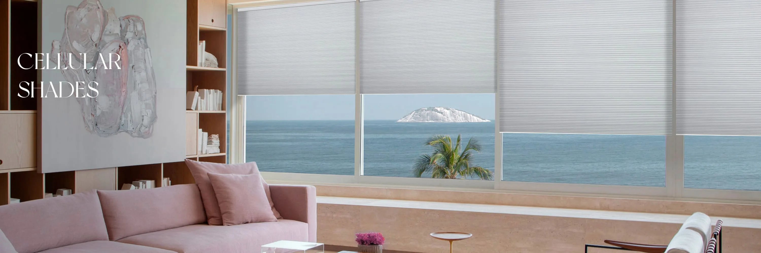 Living room with a large window featuring cellular shades, overlooking a scenic view.