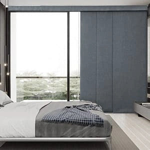 A bedroom with Panel Track Blinds.