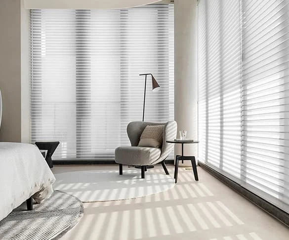 Modern bedroom with large windows covered by Smart Shangrila Shades.