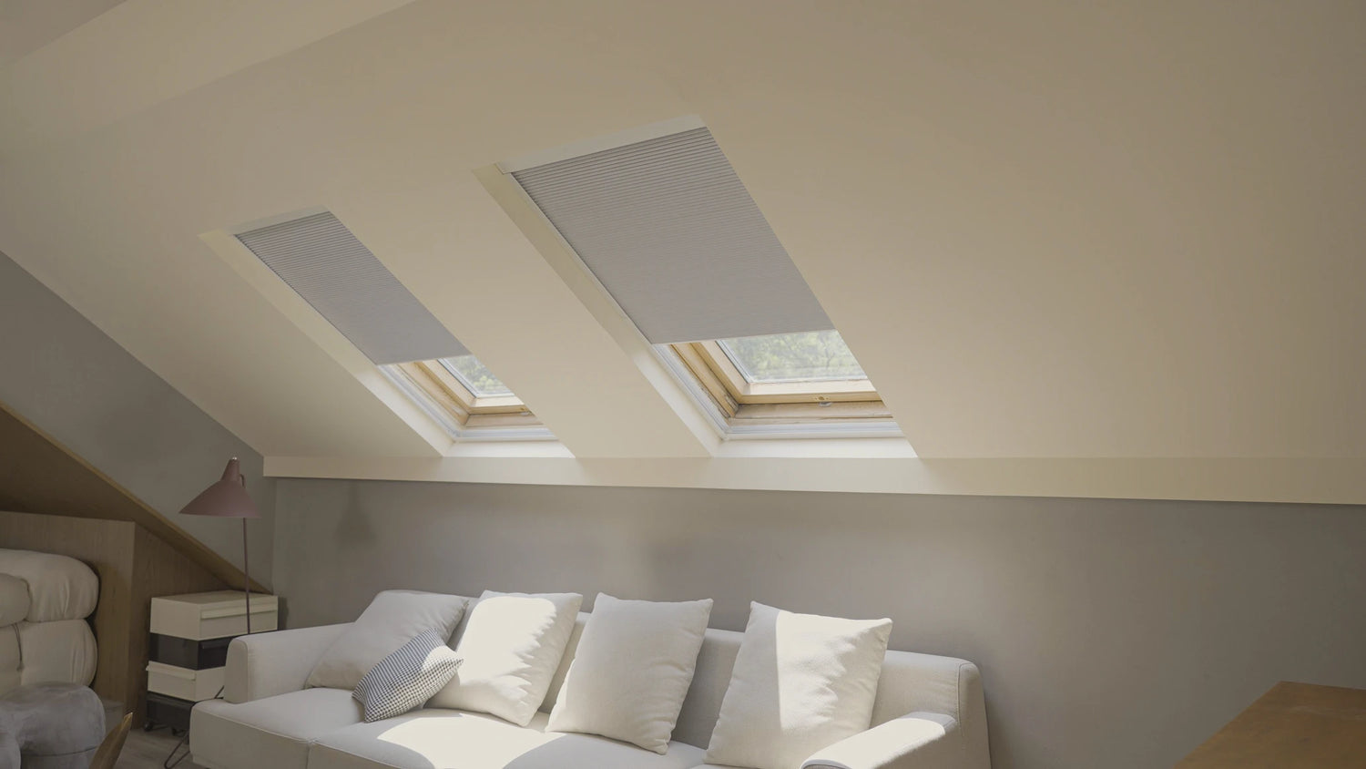 Living room with white sofa and skylights covered by skylight blinds.