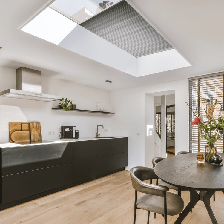 Modern kitchen with skylight covered by skylight cellular shades.