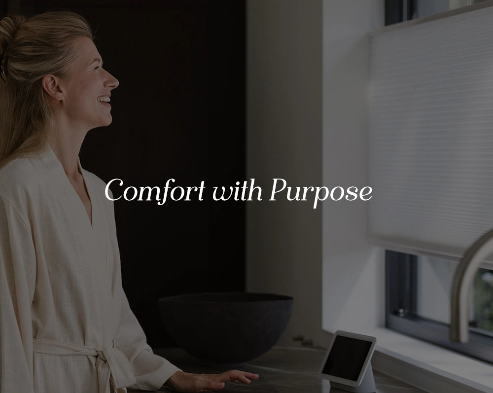 Woman in a robe interacting with a device on a counter, with text 'Comfort with Purpose' overlayed.