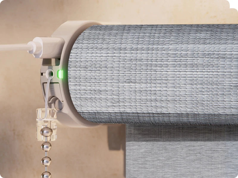 Close-up of a roller blind mechanism with a green light indicator.