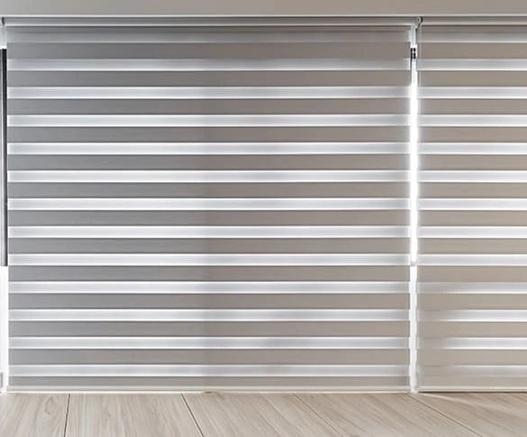 Window blinds with zebra blinds on a light wooden floor.